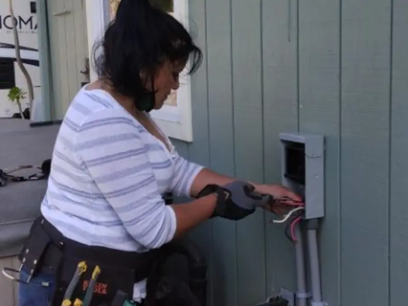 Licensed electrician wiring an exterior subpanel in Redwood